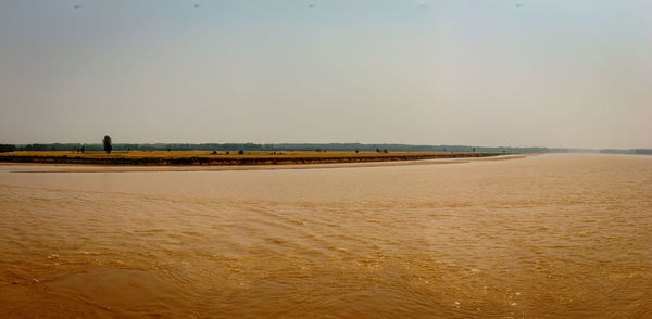 Scenic view of beach against clear sky