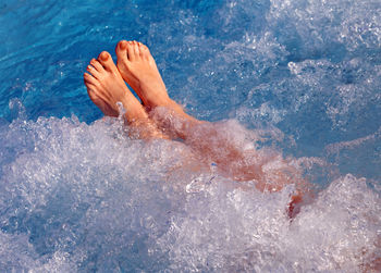 Low section of woman swimming in sea