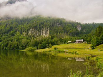 Scenic view of lake by trees against sky