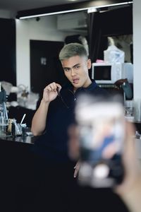 Portrait of woman photographing