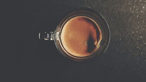 Directly above shot of beer in glass on table