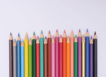 Close-up of colored pencils against white background