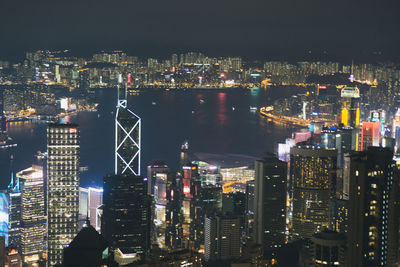 Illuminated cityscape against sky at night