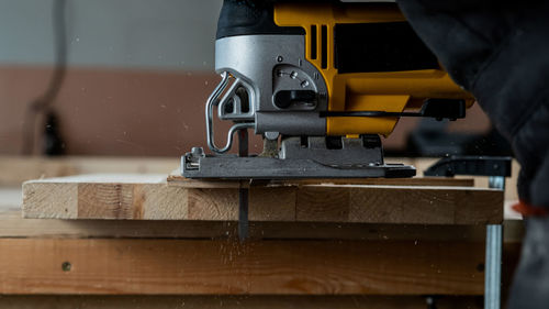 Midsection of man working in workshop