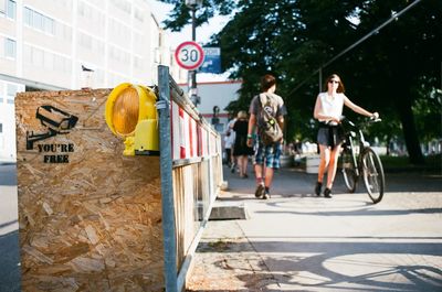 Full length of man with bicycle on road in city