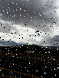 Full frame shot of wet glass window during rainy season