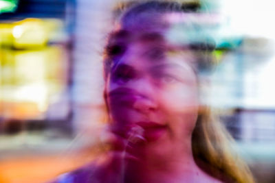Close-up of young woman against blurred background