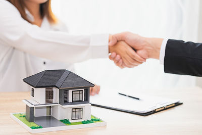 Low angle view of people on table against building