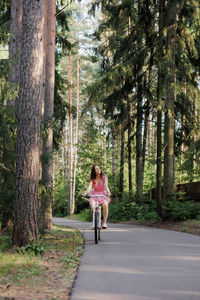 Rear view of woman walking in forest