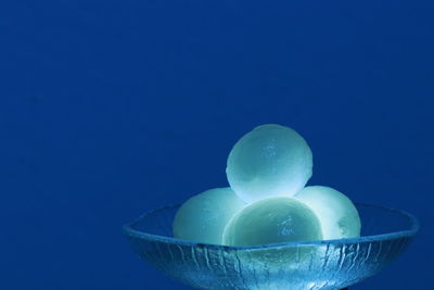 Close-up of blue glass bowl on table