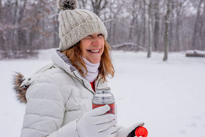 Portrait of smiling woman in snow