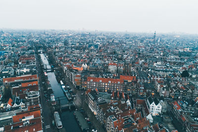 High angle view of city buildings against sky