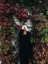 Woman standing by tree