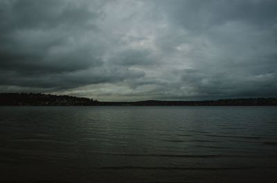 Scenic view of sea against storm clouds