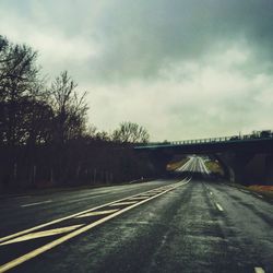 Railroad track against cloudy sky