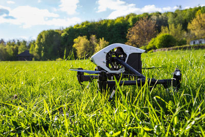 Dron is located in the green grass before takeoff. copter engine is not running. 