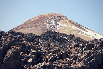 Scenic view of mountains against clear blue sky