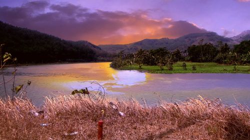 Scenic view of lake against sky during sunset