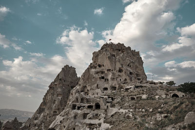 Low angle view of rock formation against sky