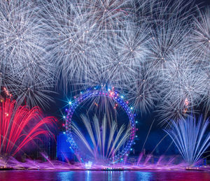 Low angle view of firework display at night