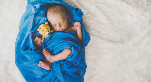 High angle view of cute baby girl on snow