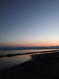 Scenic view of sea against sky at sunset