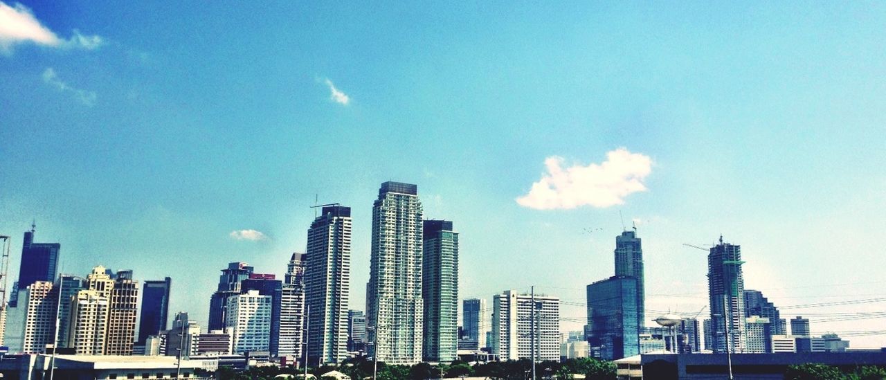 building exterior, city, architecture, skyscraper, built structure, modern, sky, office building, cityscape, tall - high, urban skyline, tower, blue, financial district, cloud - sky, low angle view, building, skyline, cloud, city life