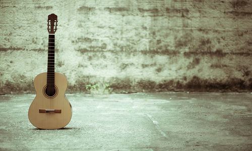 Close-up of guitar on wall