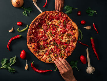 Close up of pizza slices against black background