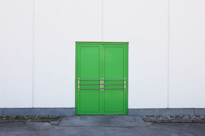 Closed green door of building