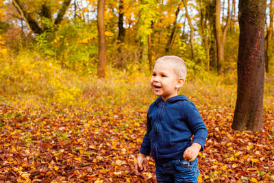 Boy in forest during autumn