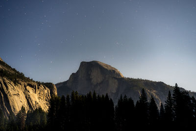 Low angle view of mountains against sky at night