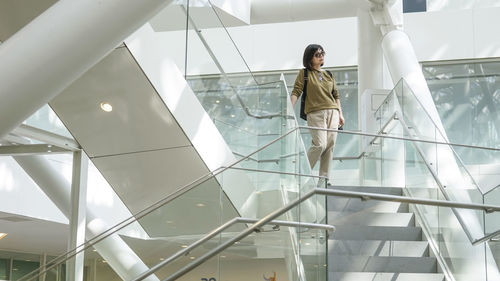 Woman standing in the white ladder