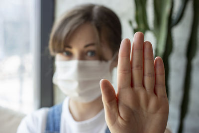 Portrait of a girl in a white medical mask, concept of quarantine, selective focus.