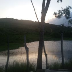 Scenic view of lake against sky during sunset