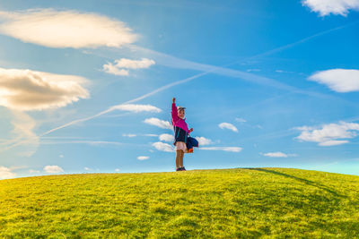 Scenic view of grassy field against cloudy sky