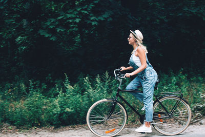 Man riding bicycle in forest