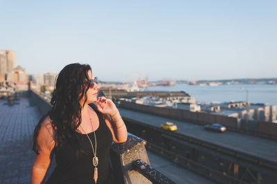 Young woman standing at building terrace 