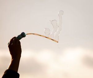 Close-up of hand holding water drop