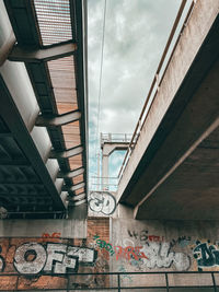 Low angle view of graffiti on building against sky