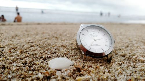 Close-up of clock on beach