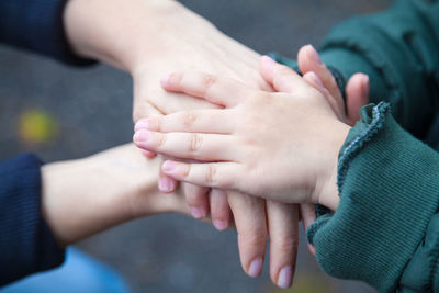 Midsection of couple holding hands