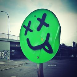 Low angle view of road sign against blue sky