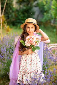 Portrait of young woman with bouquet