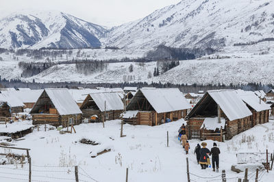 Houses on snowcapped mountains during winter