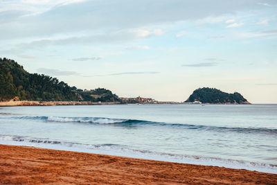 Waves and morning light on the beach in basque country, spain