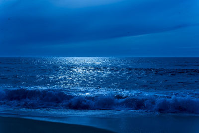 Scenic view of sea against blue sky