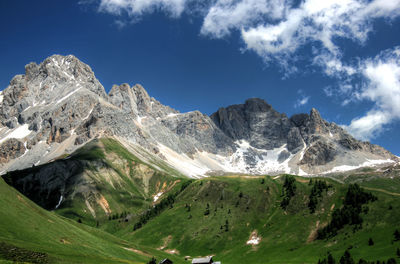 Low angle view of mountain against blue sky