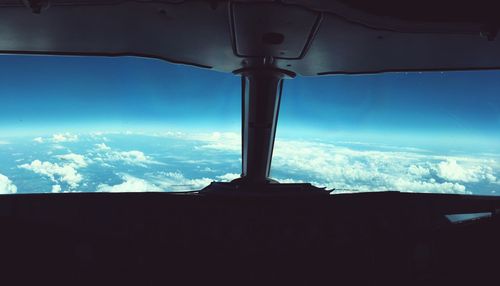 Silhouette of tree against blue sky