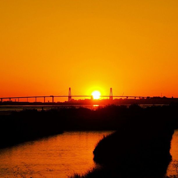 sunset, orange color, sun, silhouette, copy space, clear sky, water, built structure, bridge - man made structure, connection, architecture, beauty in nature, scenics, nature, tranquility, river, sunlight, tranquil scene, transportation, bridge